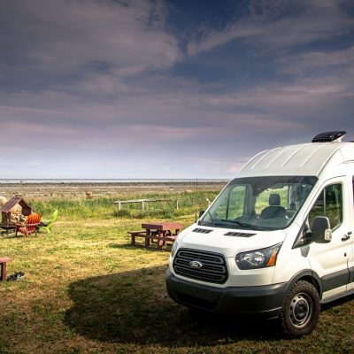 white van on green grass field during daytime